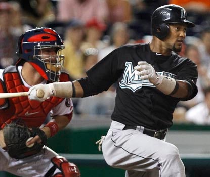 Emilio Bonifacio follows through on his eighth-inning hit, extending his streak to 25 games. (AP)