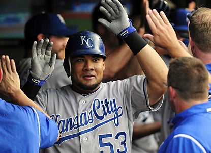 Teammates cheer Melky Cabrera in the dugout after his grand slam shot in the fourth inning. (Getty Images)