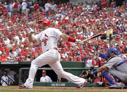 Albert Pujols follows through on the 432nd HR of his career -- a solo shot in the first inning against the Cubs. (AP)
