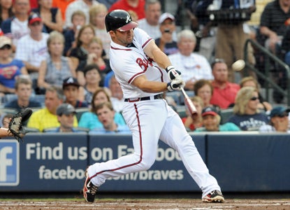 After driving in a three-run shot against the Marlins, Dan Uggla raises his career-best hitting streak to 21 games.  (Getty Images)