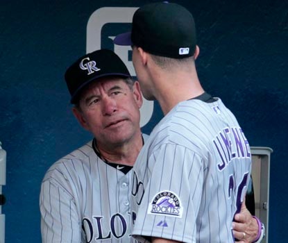 Rockies pitching coach Bob Apodaca speaks with Ubaldo Jimenez after his trade to Cleveland became official in the first inning. (AP)