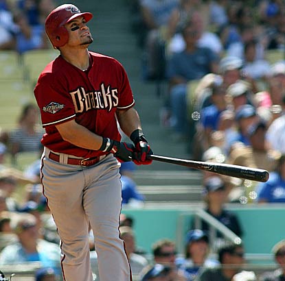 Gerardo Parra watches as one of his two homers soars past the outfield wall.  The D-Backs move within two games of the Giants. (AP)