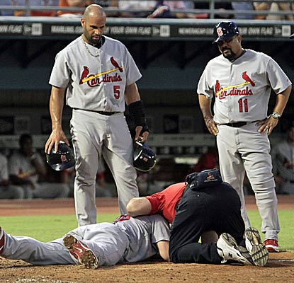 David Freese leaves the game with a mild concussion after being struck in the head by a pitch in the third inning. (AP)