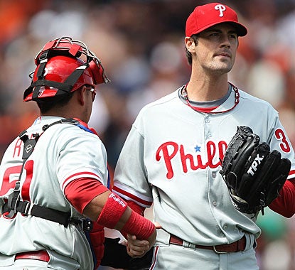 Catcher Carlos Ruiz congratulates Cole Hamels, who takes a shutout into the ninth before settling for the win. (Getty Images)