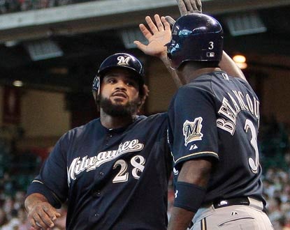 Prince Fielder accepts congratulations from Brewers teammate Yuniesky Betancourt after scoring in the third inning. (Getty Images)