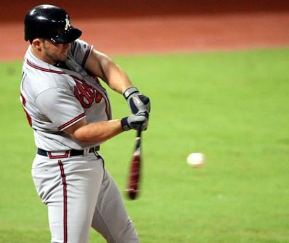 For the second straight night, Dan Uggla records an infield single to keep his hitting streak alive. (Getty Images)