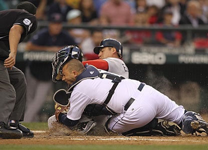 Boston's Jacoby Ellsbury is tagged out at home plate by Josh Bard on a fly ball hit by Dustin Pedroia. (Getty Images)