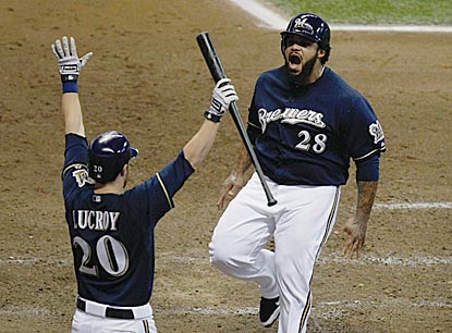 Prince Fielder celebrates with Jonathan Lucroy after scoring on Jerry Hairston's two-run single in the sixth inning.  (Getty Images)