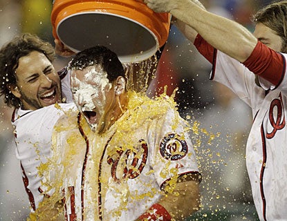 Michael Morse and Jayson Werth pour Gatorade over Ryan Zimmerman, who bashes a grand slam. (AP)