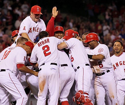Hidden amongst ecstatic Angels, Bobby Abreu receives a proper greeting after hitting in the winning run in the 12th. (Getty Images)