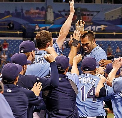 Johnny Damon celebrates with Rays teammates after hitting a walk-off home run to beat the Mariners. (Getty Images)