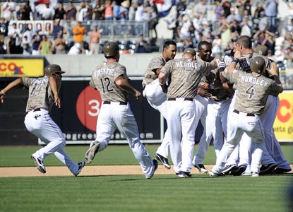 After crushing a solo shot in the first, Will Venable (getting swarmed) knocks in the game-winner in the bottom of the ninth.  (US Presswire)