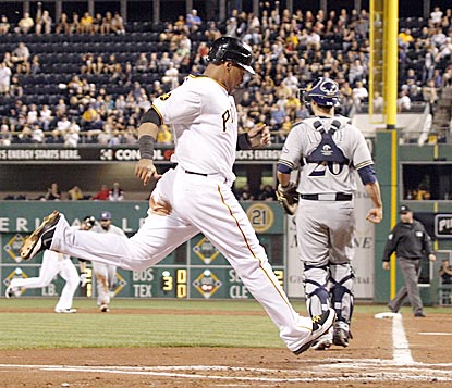 Pittsburgh's Jose Tabata, who goes 5 for 9 in the doubleheader, scores in the first inning in Game 2 on a Neil Walker hit.  (AP)