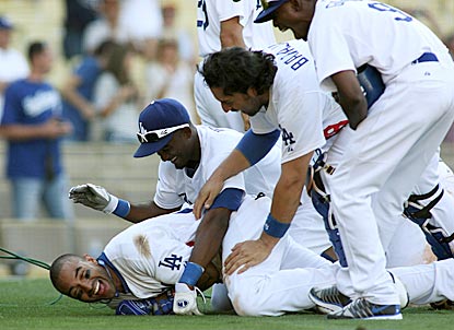 Dodgers hero Matt Kemp (bottom) gladly accepts the modern consequences of hitting a game-ending home run.  (Getty Images)