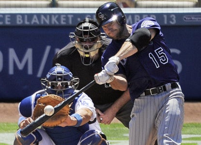 Kevin Kouzmanoff is proving to be a worthy addition to the Rockies as he bloops a three-run double in the first. (Getty Images)