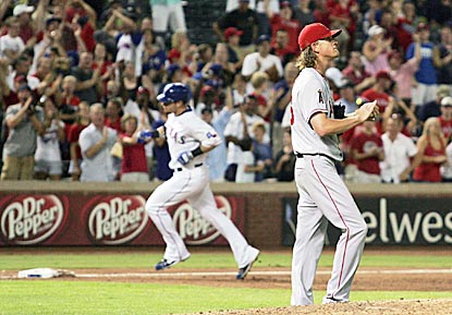 Josh Hamilton circles the bases in the third inning while Jered Weaver wonders how he squandered an early lead.  (US Presswire)