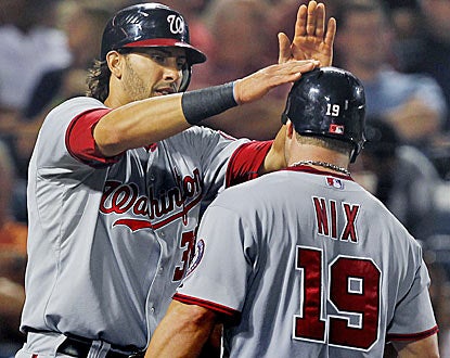 Michael Morse congratulates Laynce Nix on his home run, one of four hit by Washington. (AP)