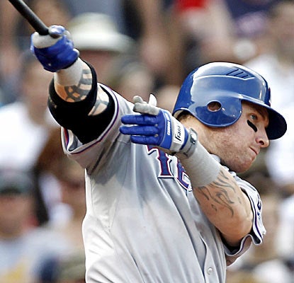 Josh Hamilton belts a bases-loaded triple to cap a seven-run sixth inning for the Texas Rangers. (AP)