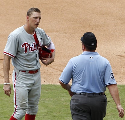 Hunter Pence talks with umpire Sam Holbrook (right) after being ruled out for fan interference in the sixth inning. (AP)