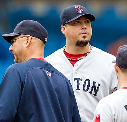 Red Sox manager Terry Francona and Josh Beckett have a word on the mound before Boston's ace leaves with a sprained ankle. (AP)