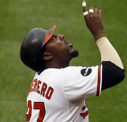 Vladimir Guerrero reacts after hitting a solo homer in the first inning. Guerrero has scored four runs in his last four games. (AP)