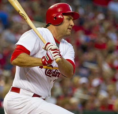 Lance Berkman follows through on his RBI double in the third inning against the Braves. (US Presswire)