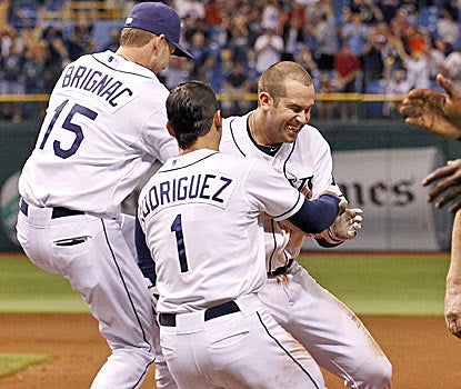 Tampa Bay's Reid Brignac and Sean Rodriguez congratulate Evan Longoria after his hit beats Boston in the 11th inning. (AP)