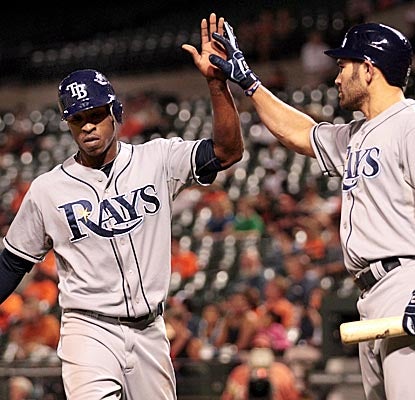 B.J. Upton (left) helps keep the Rays' wild-card hopes alive, going 4 for 4 with a walk vs. the O's. (Getty Images)