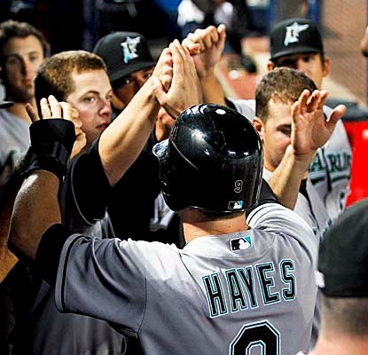 The Marlins welcome Brett Hayes into the dugout after teammate Mike Stanton brings him home the win. (US Presswire)