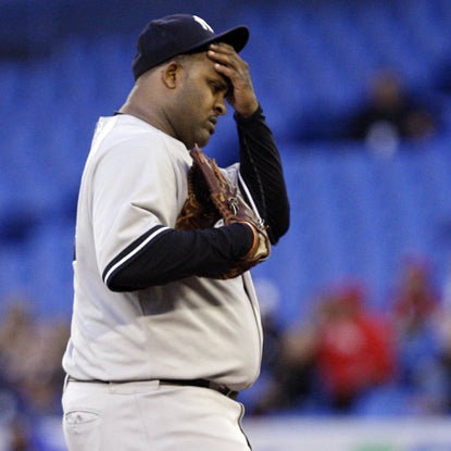 Ahead 3-1 in the fifth, CC Sabathia reacts after allowing a critical three-run double to Adam Lind. (Getty Images)