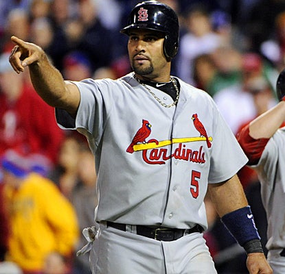 Albert Pujols celebrates after scoring on Adron Chambers' single in the 11th inning against the Phillies. (US Presswire)