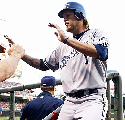 Corey Hart celebrates after scoring in the first inning against the Reds.  (Getty Images)
