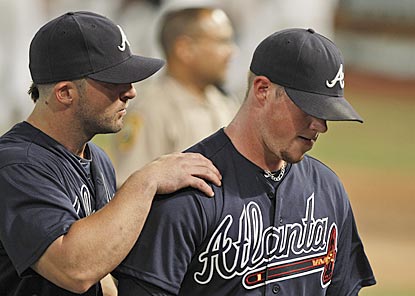 Braves second baseman Dan Uggla consoles closer Craig Kimbrel after Florida's Omar Infante ends the game in stunning fashion.  (AP)
