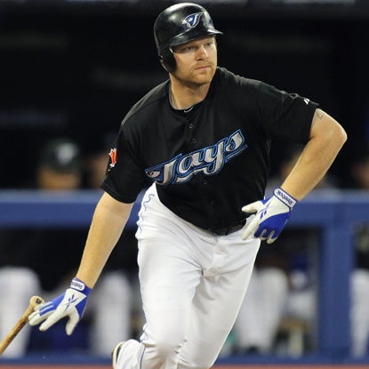 Toronto's Adam Lind drives in the go-ahead run to lift the Jays over the struggling Halos. (Getty Images)