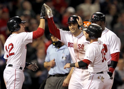 Conor Jackson's (center) grand slam caps a much-needed offensive burst that helps Boston split their doubleheader. (Getty Images)