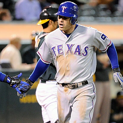 Ian Kinsler celebrates with a teammate after hitting a game-tying home run in the eighth. (Getty Images)