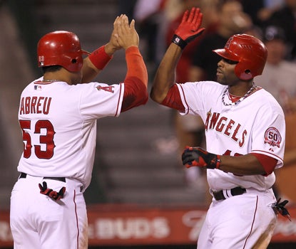 Torii Hunter (right) celebrates his HR with teammate Bobby Abreu before finishing the game with three RBI. (Getty Images)