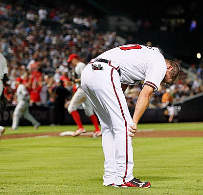 Chipper Jones has Braves fans scrambling for the exits after grounding into an inning-ending double play in the eighth. (Getty Images)
