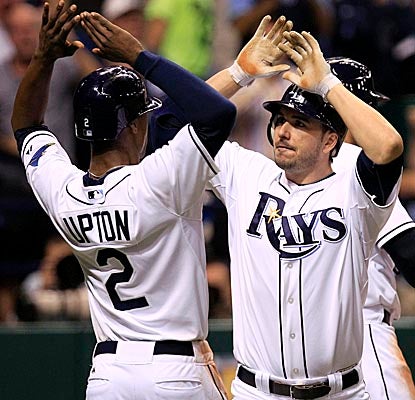 Matt Joyce (right) celebrates at home plate after his seventh-inning homer drives in three runs vs. the Yankees. (AP)