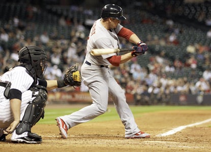 Ryan Theriot pivots toward a crucial two-run triple in the seventh which helps spark the Cardinals' victory.  (Getty Images)