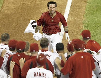 Ryan Roberts takes off his uniform top before completing his euphoric tour of the bases following his game-ending grand slam.  (AP)