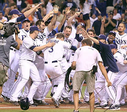 Evan Longoria stomps on home plate before Tampa Bay's jubilant players and fans after his clinching walk-off home run.  (US Presswire)