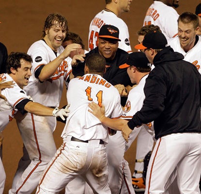 Robert Andino (11) haunts the Red Sox again with a game-winning single that sends the Orioles to celebration mode.  (Getty Images)