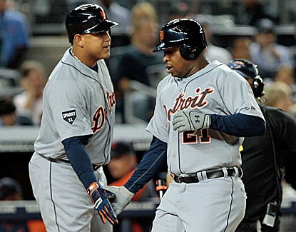 Detroit's Delmon Young celebrates with teammate Miguel Cabrera after hitting a solo home run in the first inning. (Getty Images)