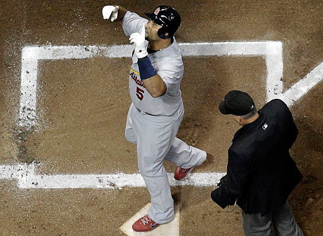 Pujols touches home in the first for what is one of his five RBI for the Cards in Game 2. (AP)