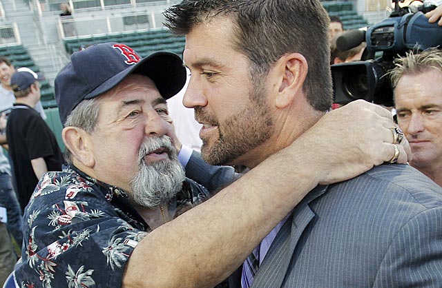 Jason Varitek gets a hug from his father Joe after making his announcement. (AP)