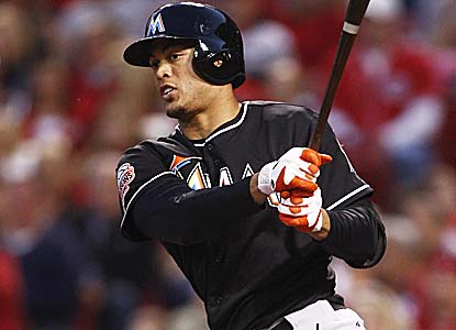 Giancarlo Stanton drives in three runs for Miami, which scored just one in losing its first two games. (Getty Images)