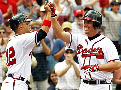 Chipper Jones celebrates after hitting a three-run home run in his first game back from a two-game layoff. (AP)