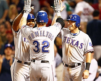 Elvis Andrus (left) and Ian Kinsler (right) celebrate with Josh Hamilton after he clobbers a home run in the eighth inning. (US Presswire)