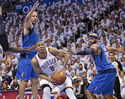Russell Westbrook, who winds up with 29 points, finds a way around Jason Kidd (left) and Vince Carter in the first half.  (Getty Images)